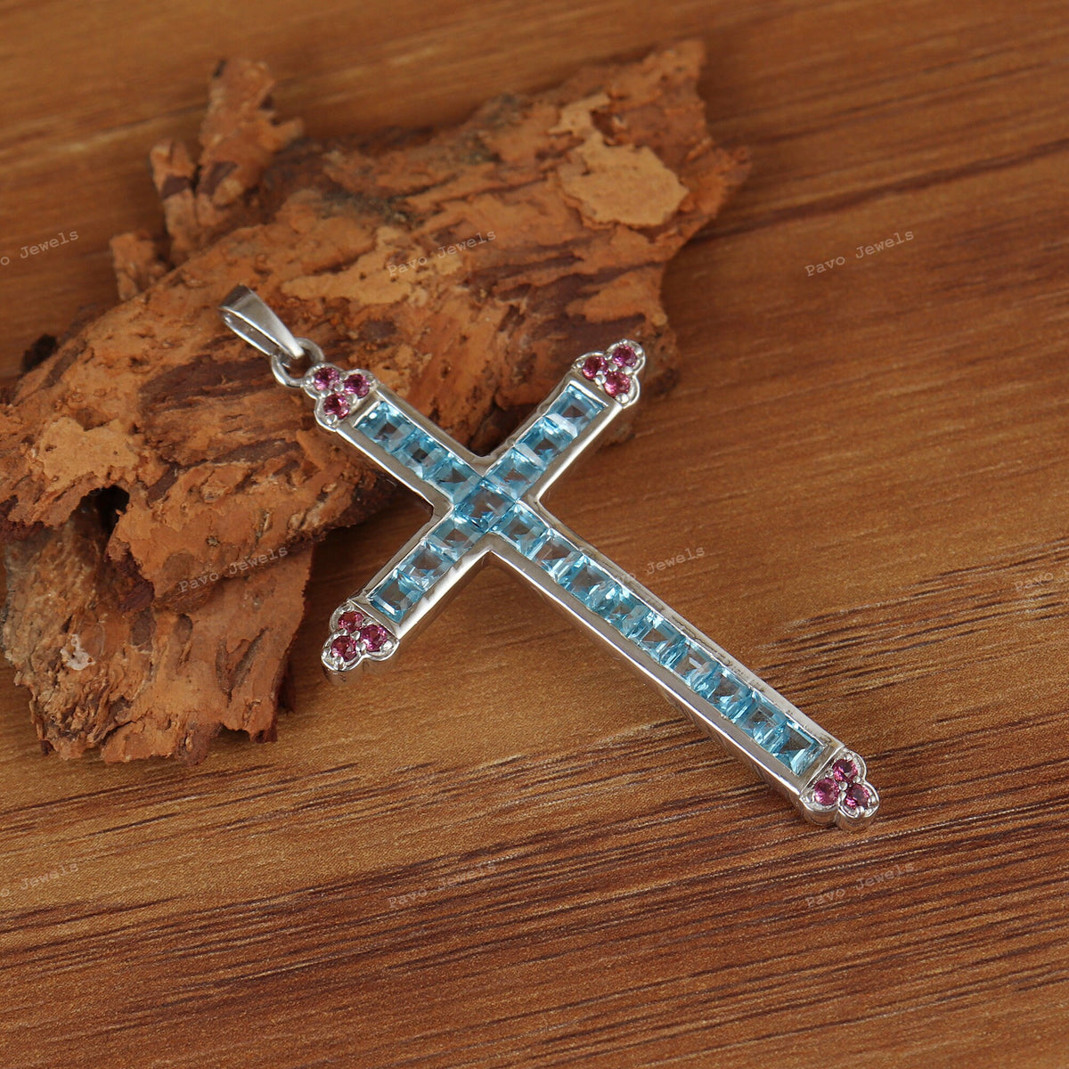 Swiss Blue Topaz Cross Pendant: Sterling Silver Garnet Accent