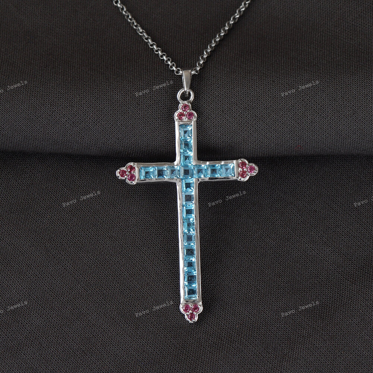 Swiss Blue Topaz Cross Pendant: Sterling Silver Garnet Accent