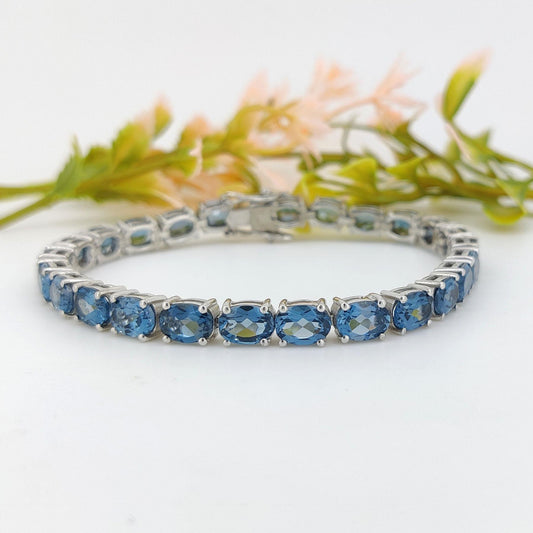 London Blue Topaz Tennis Bracelet: Sterling Silver Oval Gemstone, December Birthstone
